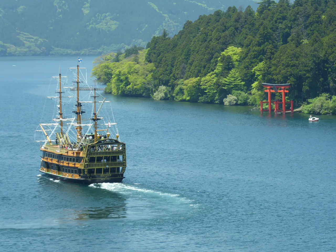 A boat and a Shinto arch on Lake Ashi, Hakone, Japan
