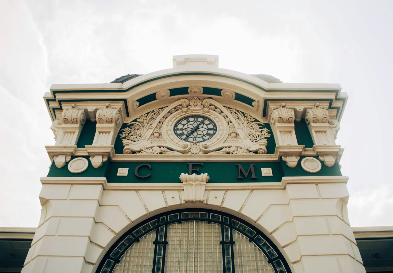 a clock on top of a building with a sky background