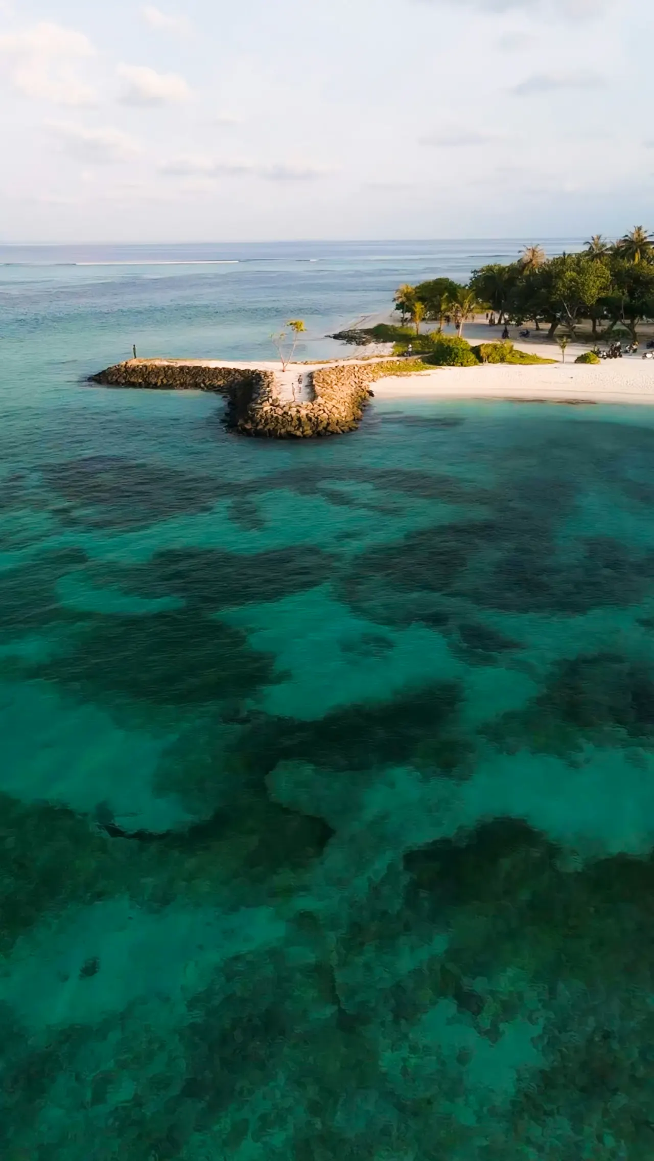 Vibrant blue water meets a white sandy beach