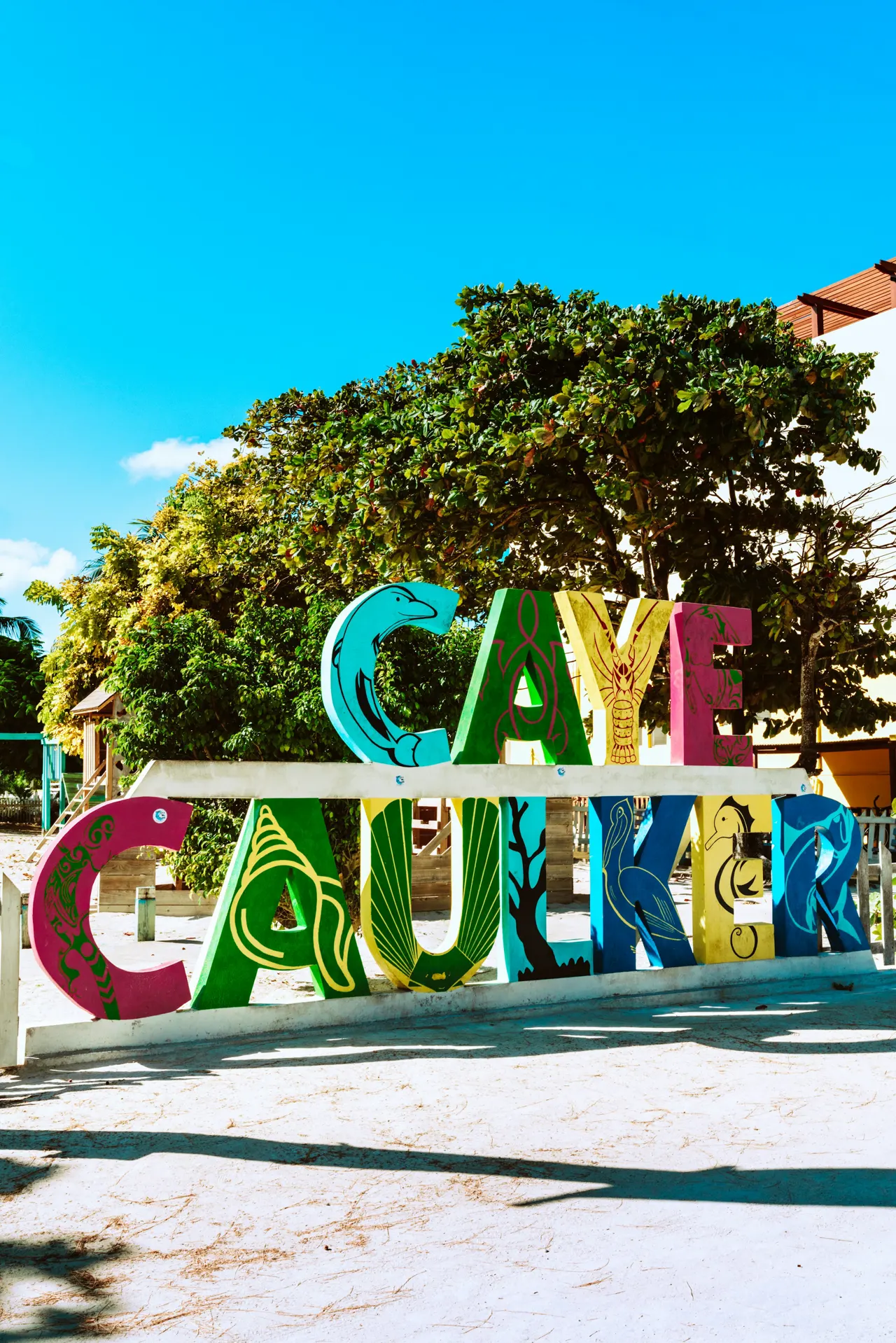 Giant hand-painted letters sign that reads "Caye Caulker"