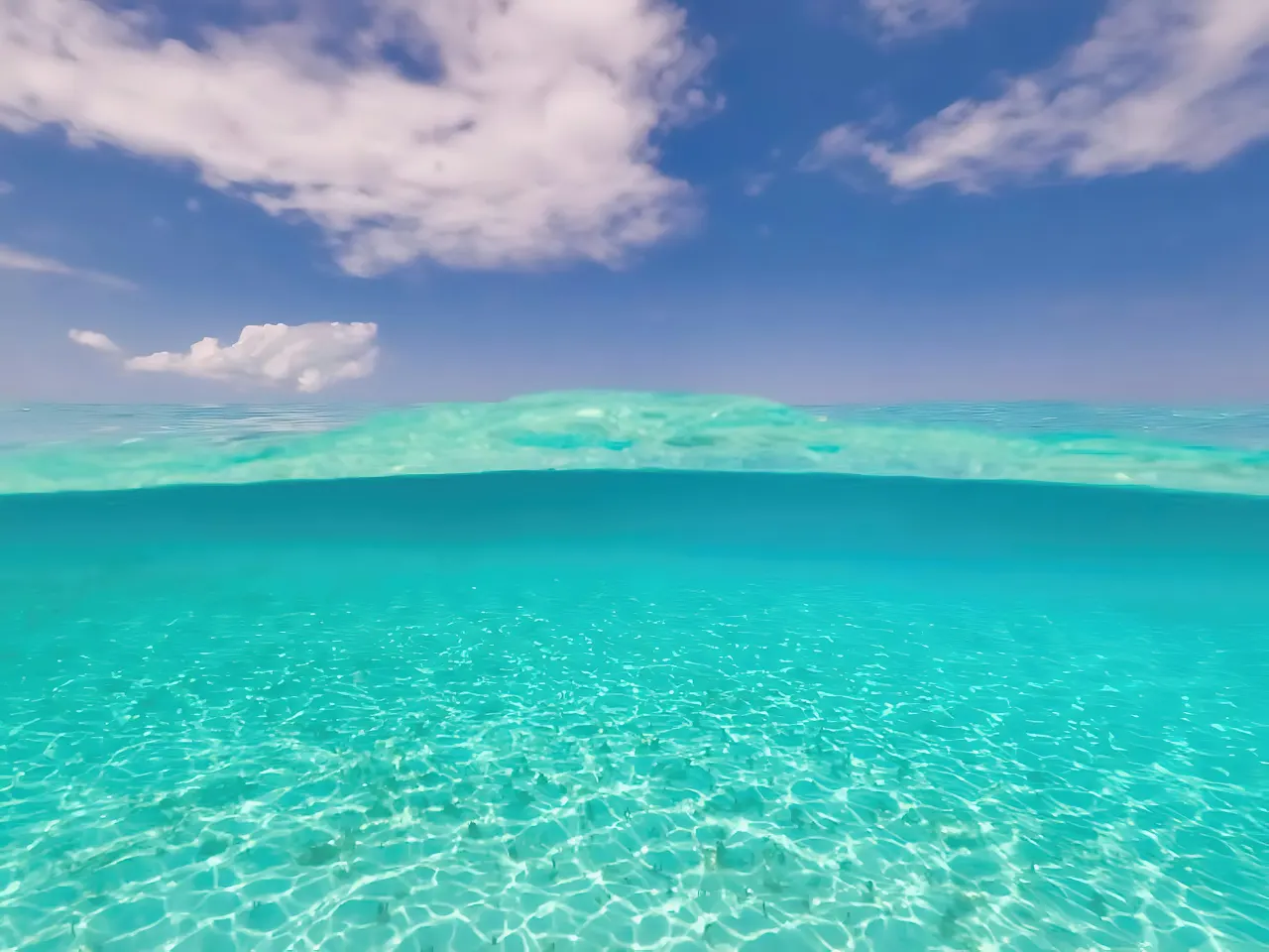 Crystal clear turquoise water under a bright blue sky