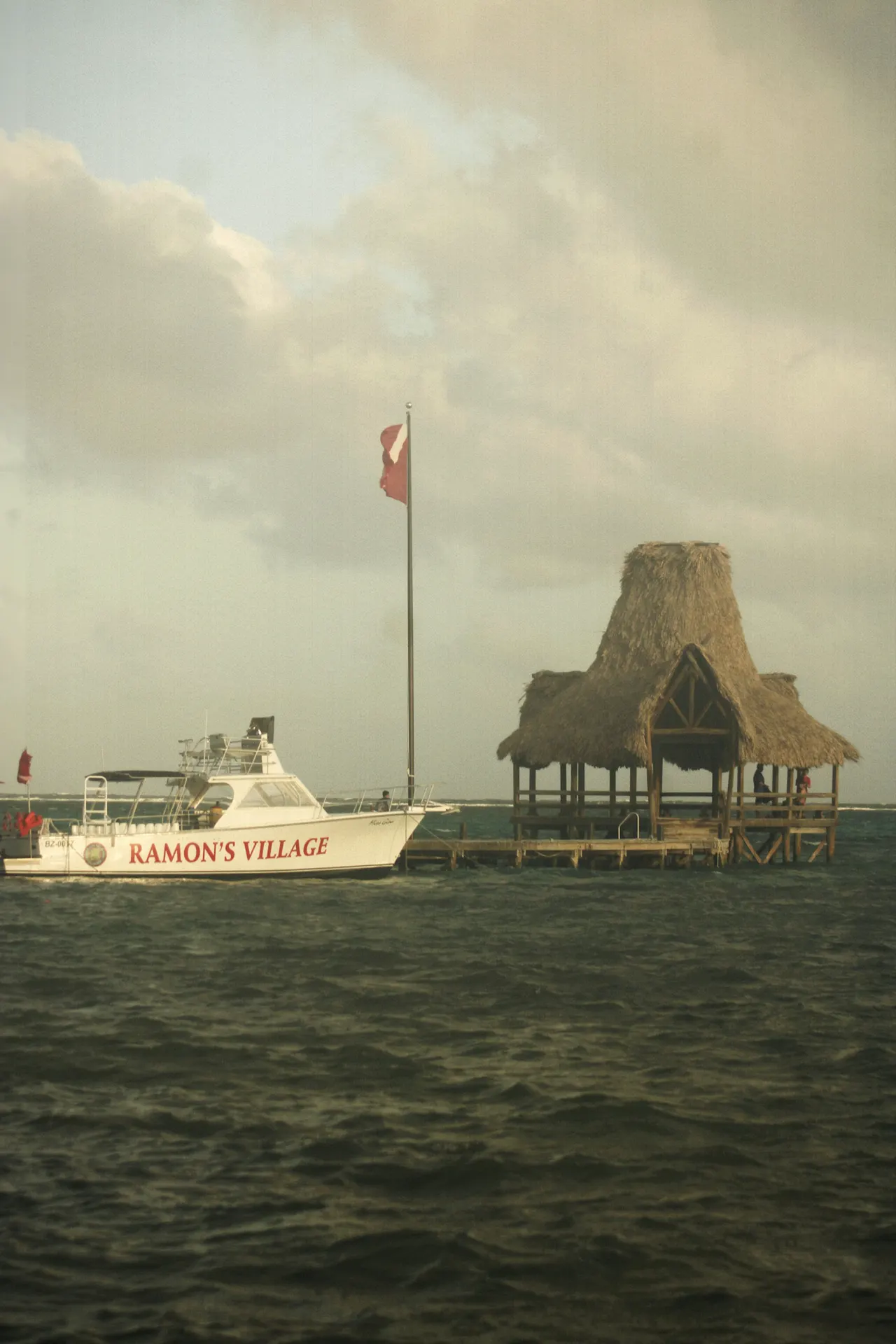 A boat is in the water near a pier