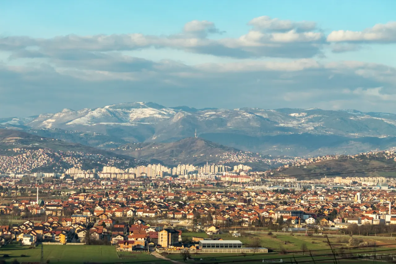 a view of a city with mountains in the background