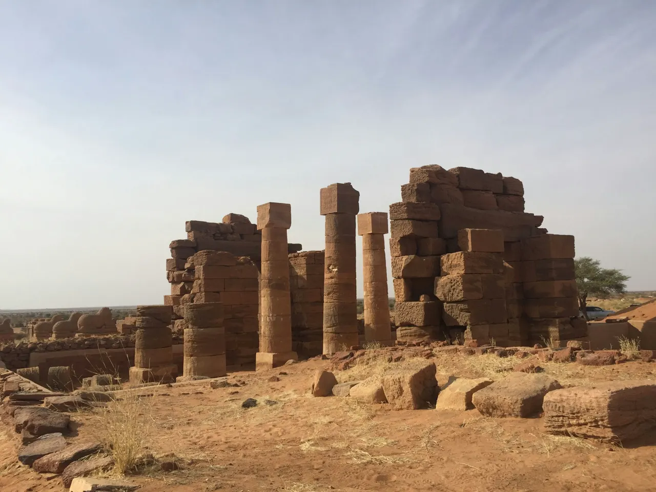 Ancient stone ruins with tall pillars under a clear sky