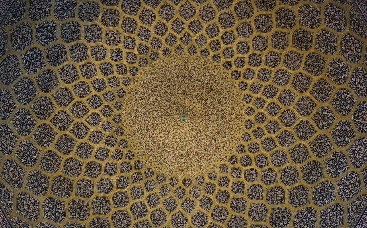Intricate blue and gold geometric tile patterns radiating across a domed ceiling