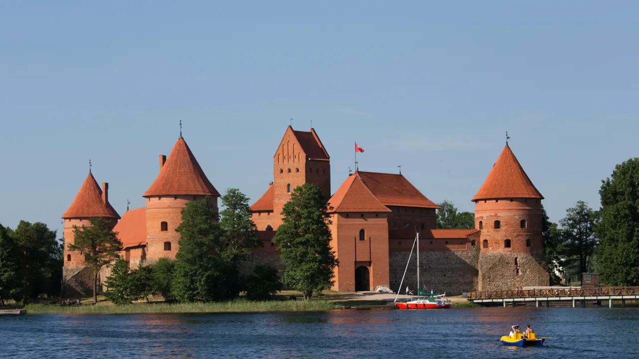 a boat is in the water in front of a castle