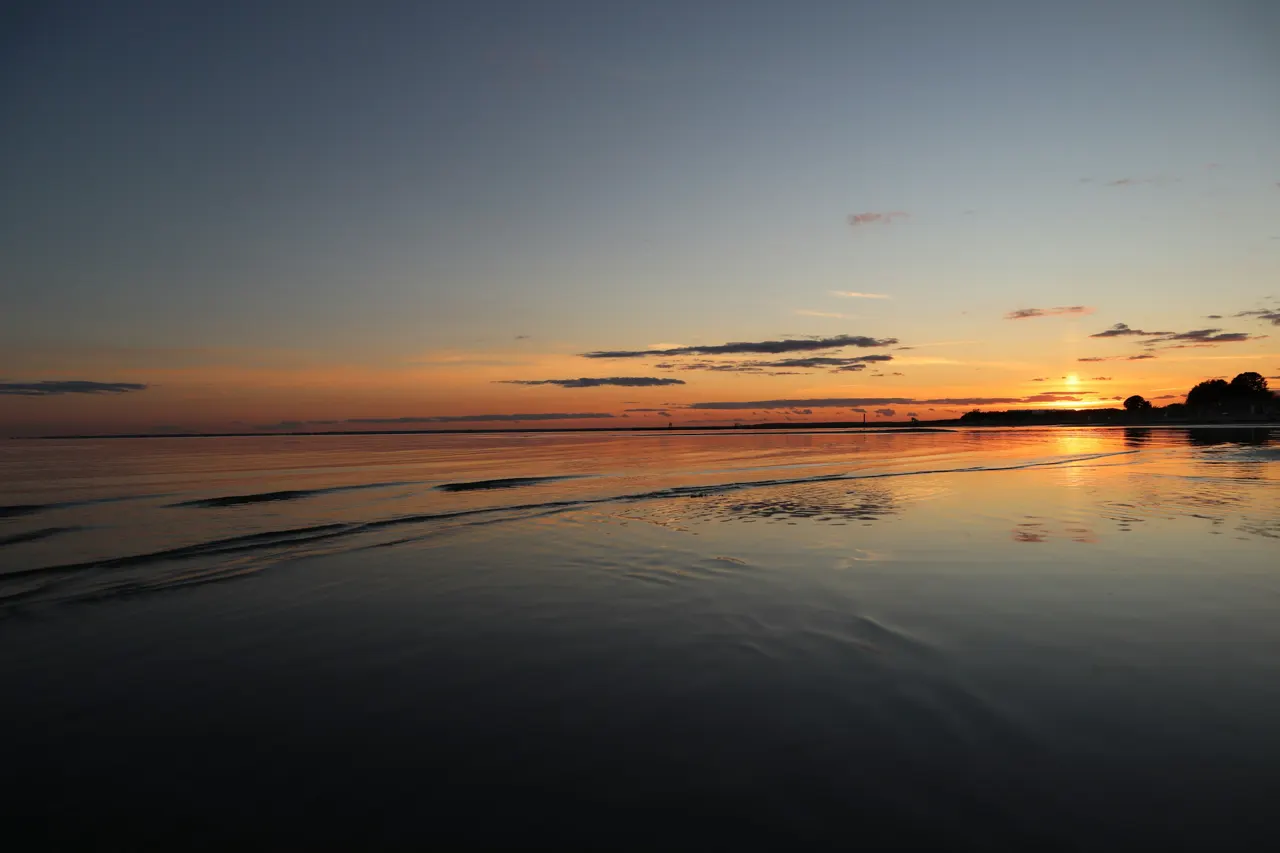 body of water during sunset