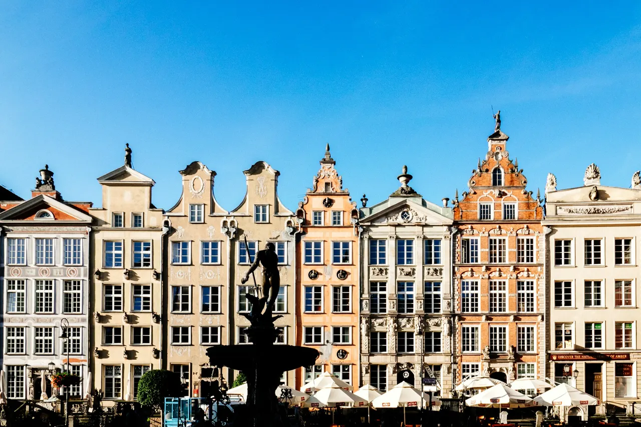 The morning light shines on the back of the statue of Neptune in Gdansk’s Main Town