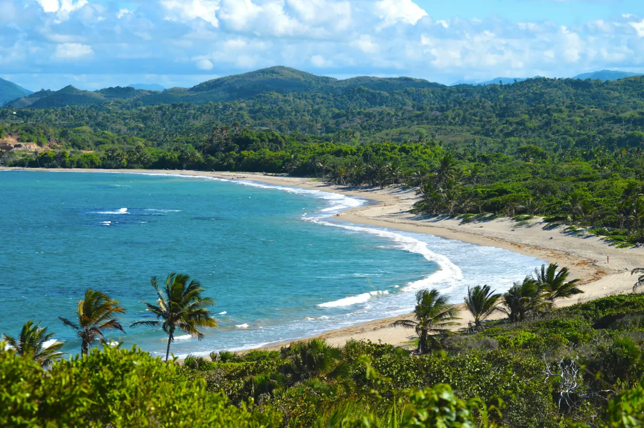 A view of a beach with a boat in the water