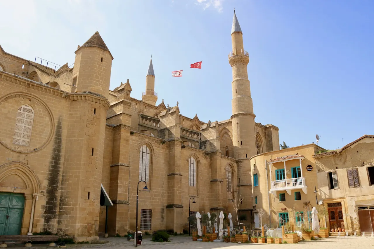 an old building with a flag flying in front of it