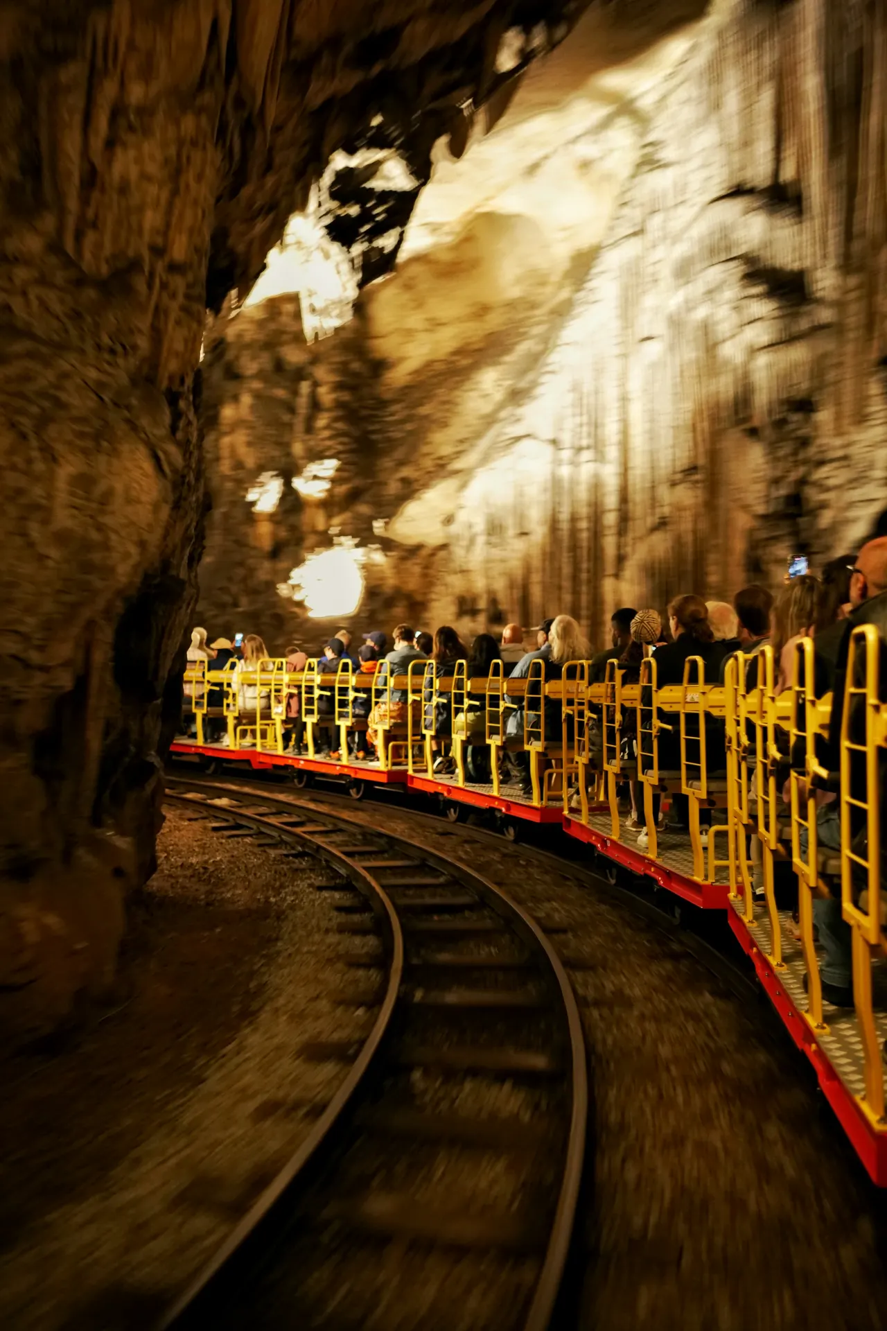 A high speed shot of a train going through Postonja caves, the train is in focus and the rest do the area is blurry