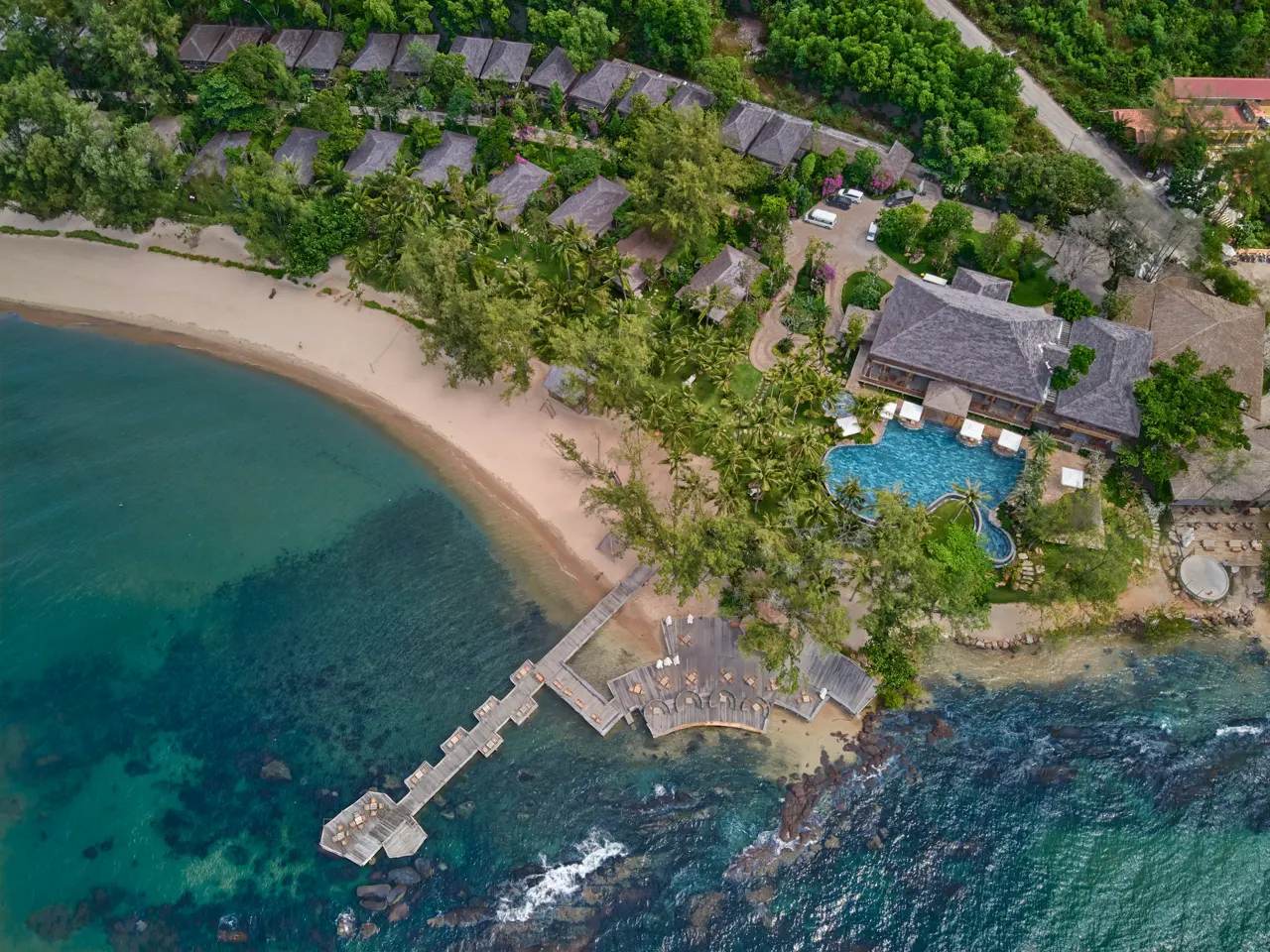 an aerial view of a resort on the ocean