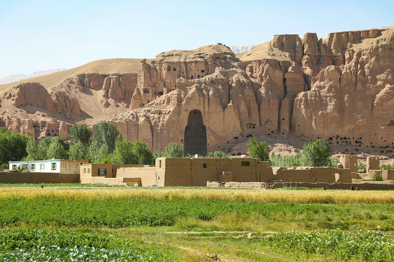 Ancient buddha statue ruins with surrounding landscape