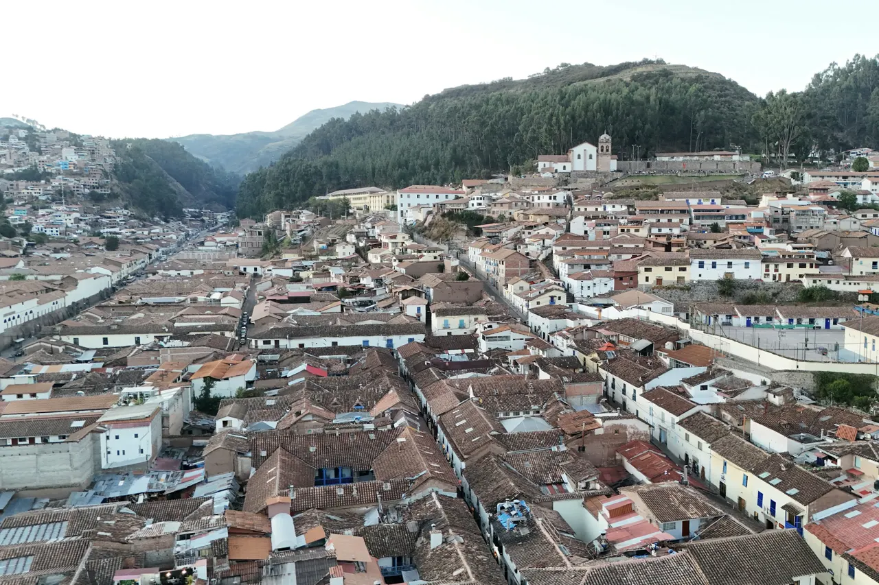 An aerial view of a city with mountains in the background