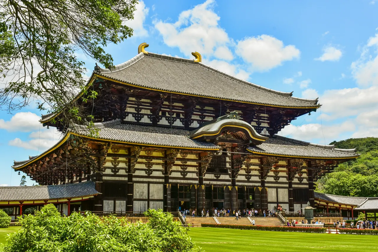A large wooden building sitting on top of a lush green field