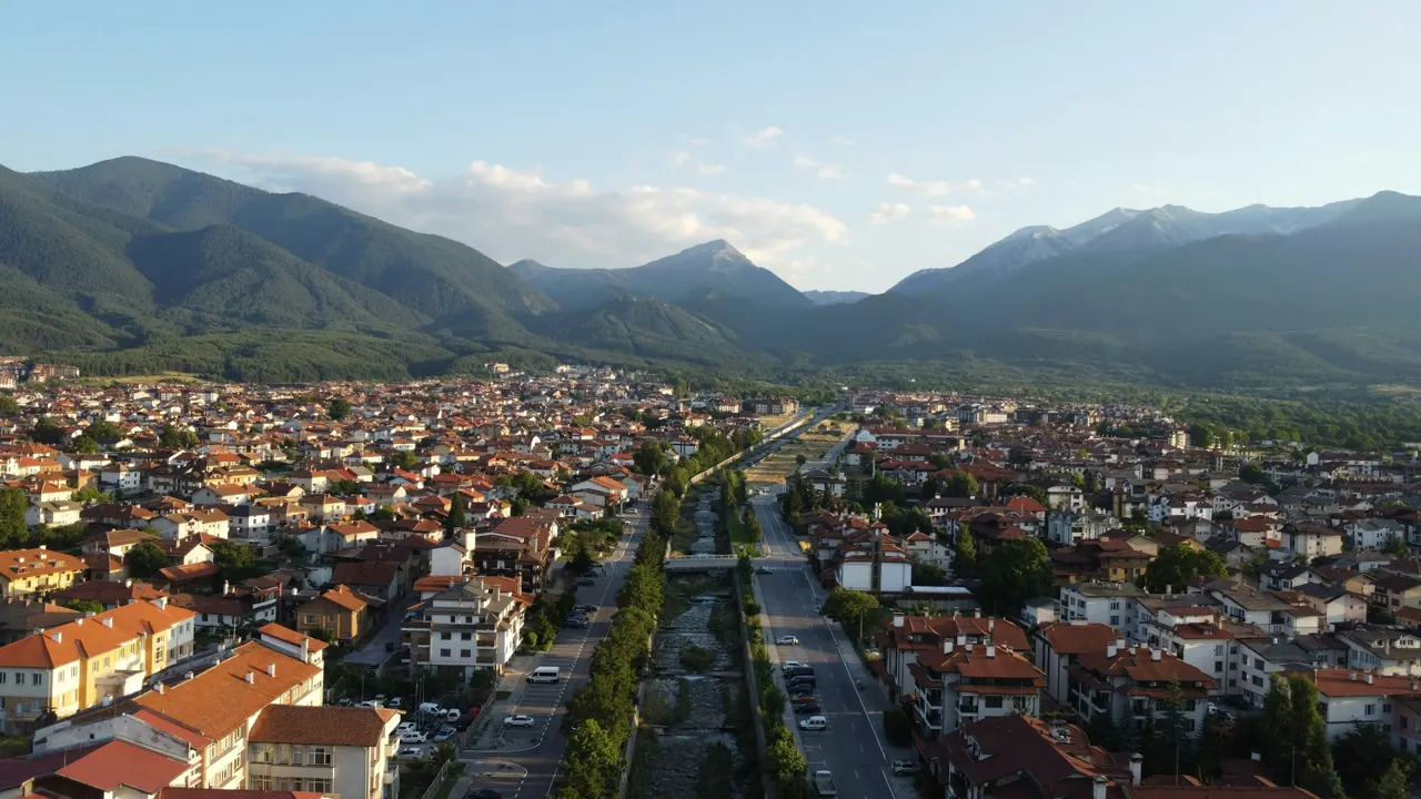 An aerial view of a city with mountains in the background