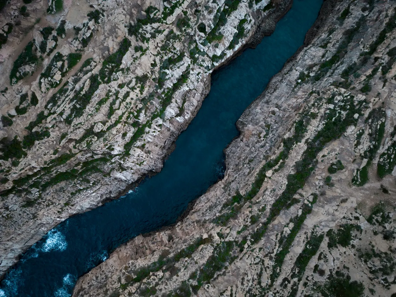 an aerial view of a river running through a canyon