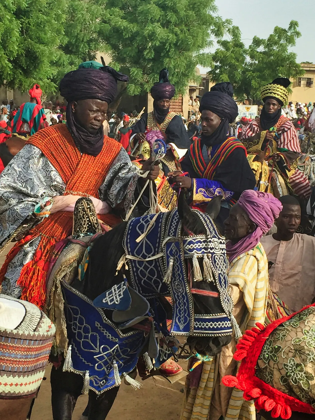 Participants in the Hawan Daushe Durbar The Emir and his entourage ride through a number of quarters housing historically significant families before returning to the palace via the Kofar Kudu gate for the Jahi - the horsemen's salute