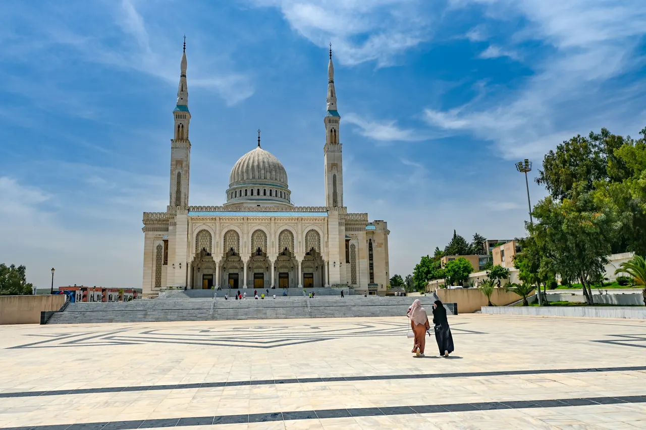A large mosque stands with tall minarets