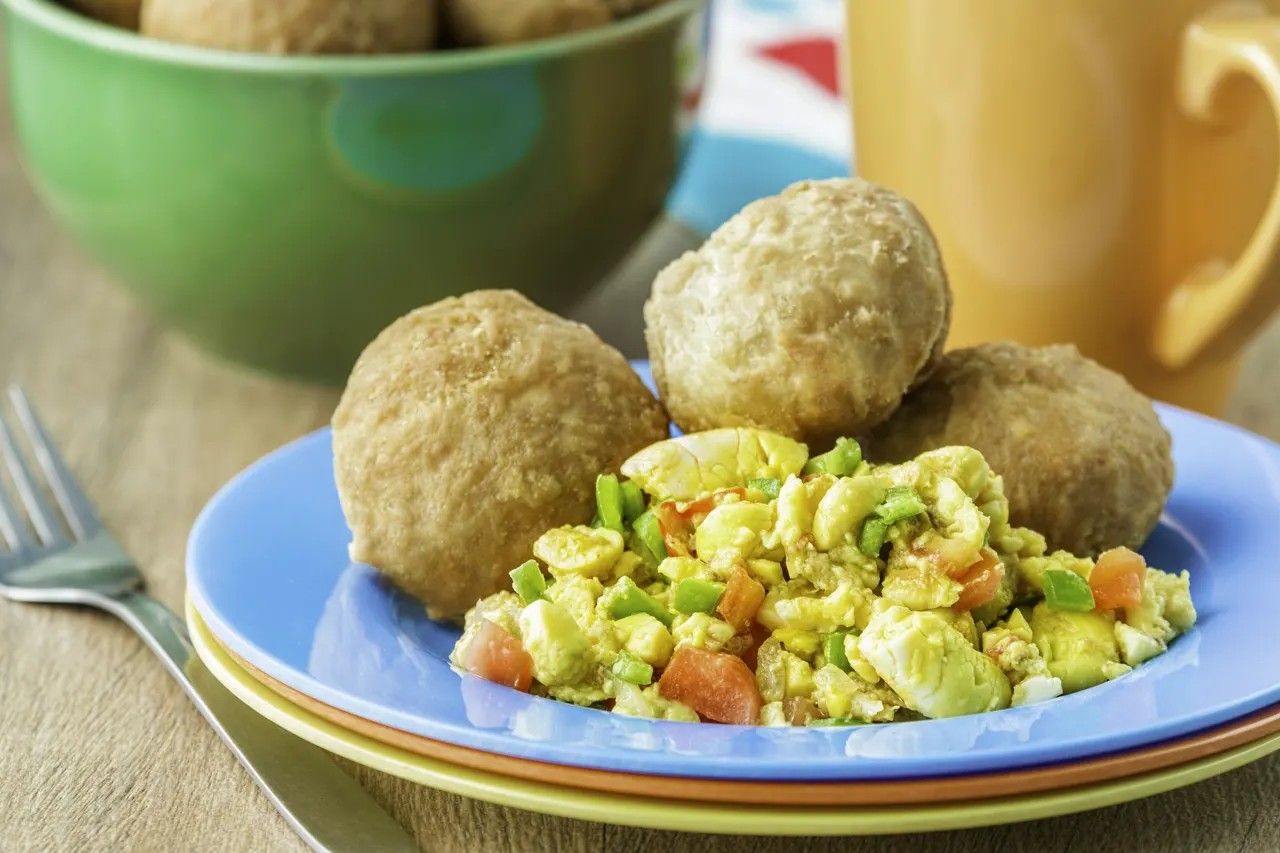Jamaican ackee and saltfish served with a side of fried dumplings