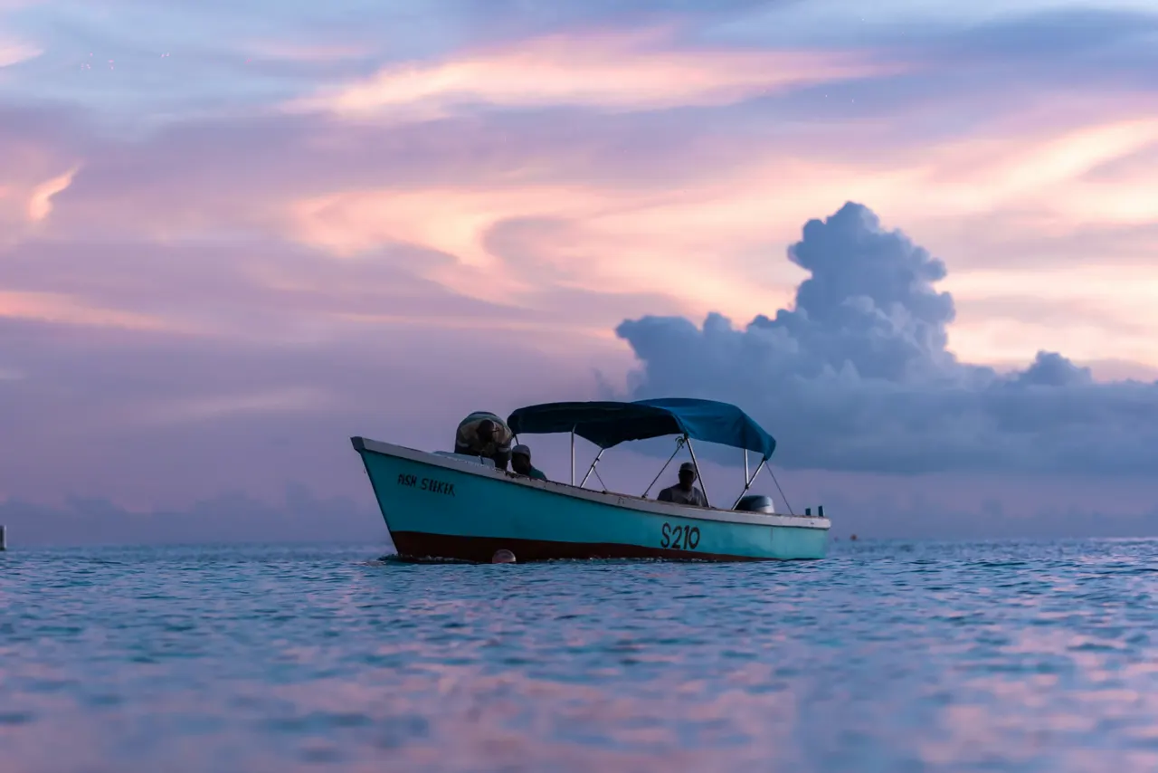 Fishermen returning to land at sunset