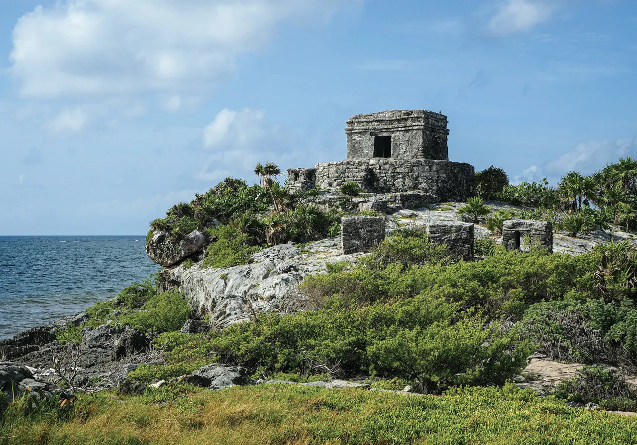 a stone structure on a rocky outcrop near the ocean