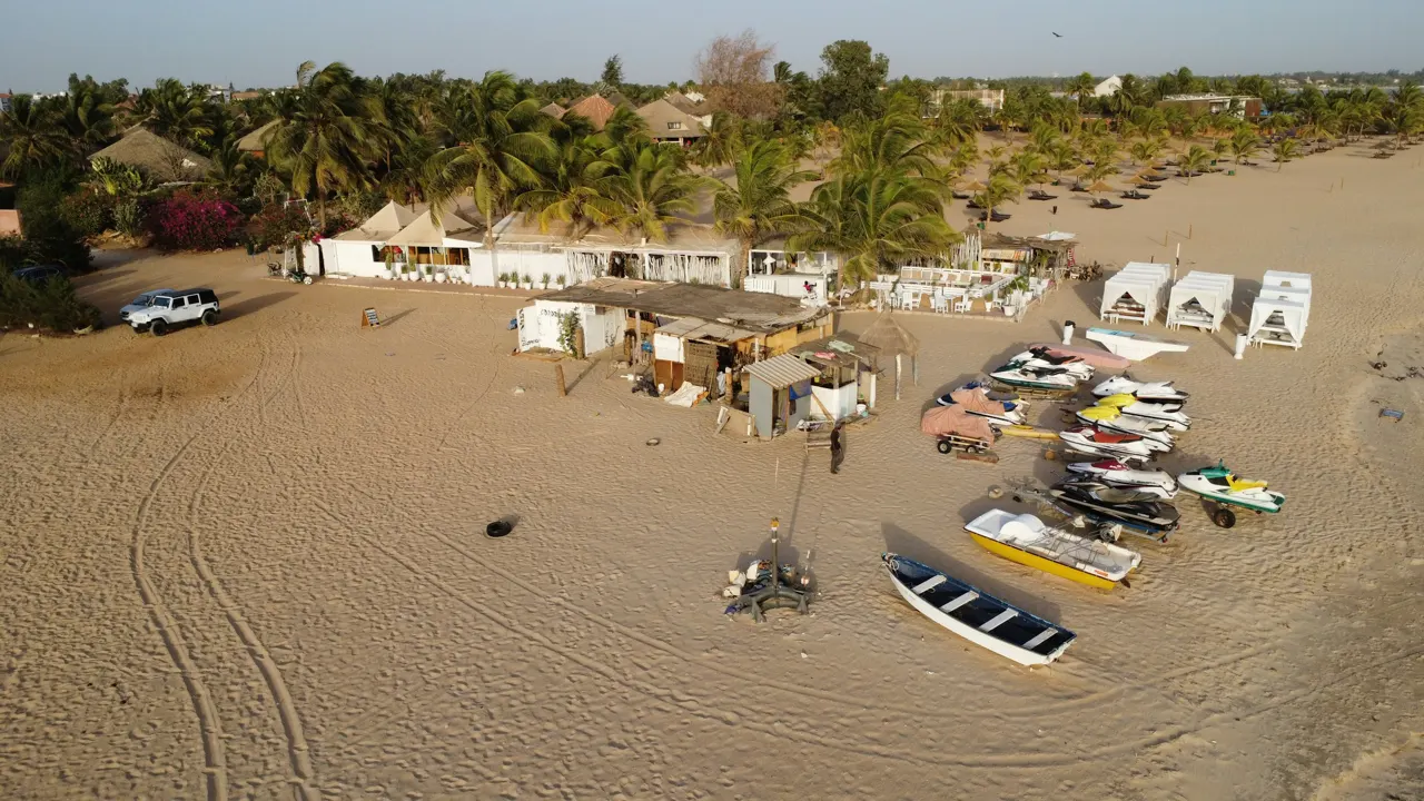 Boats and a beachside restaurant on the sand