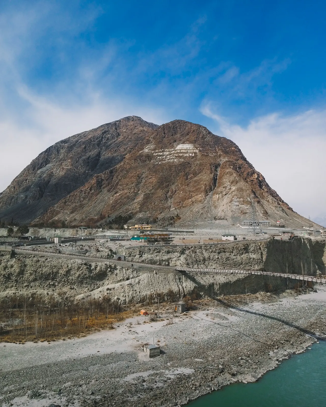 a large mountain with a bridge in the middle of it