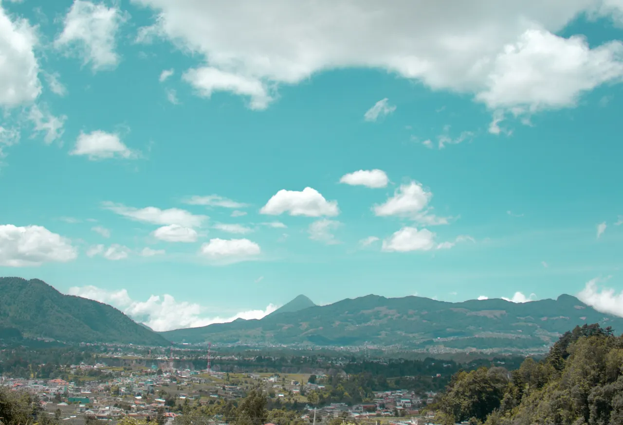 A scenic view of a city with mountains in the background