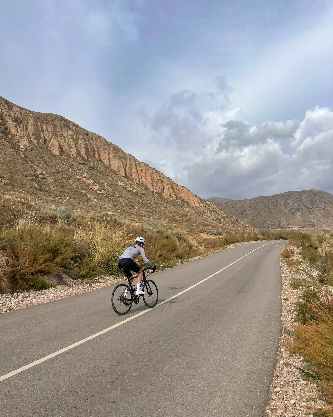 a person riding a bicycle on a road