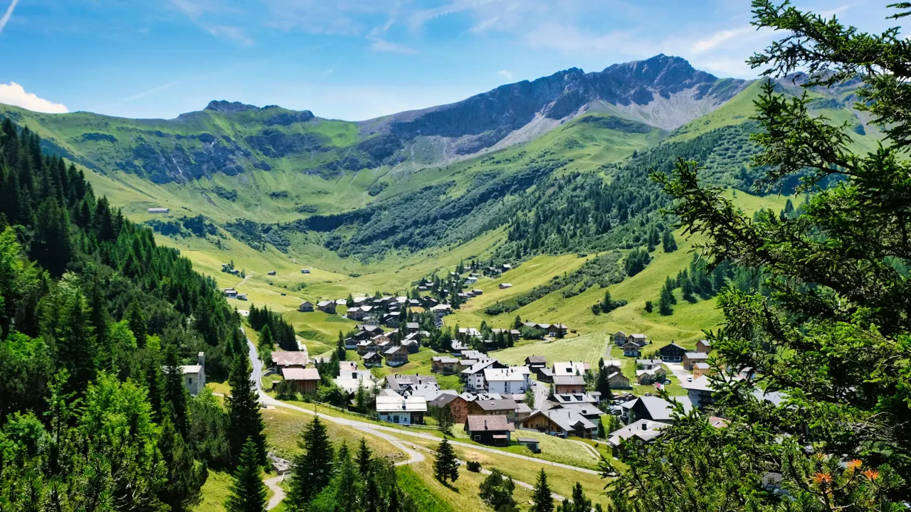 a village nestled in a valley surrounded by mountains