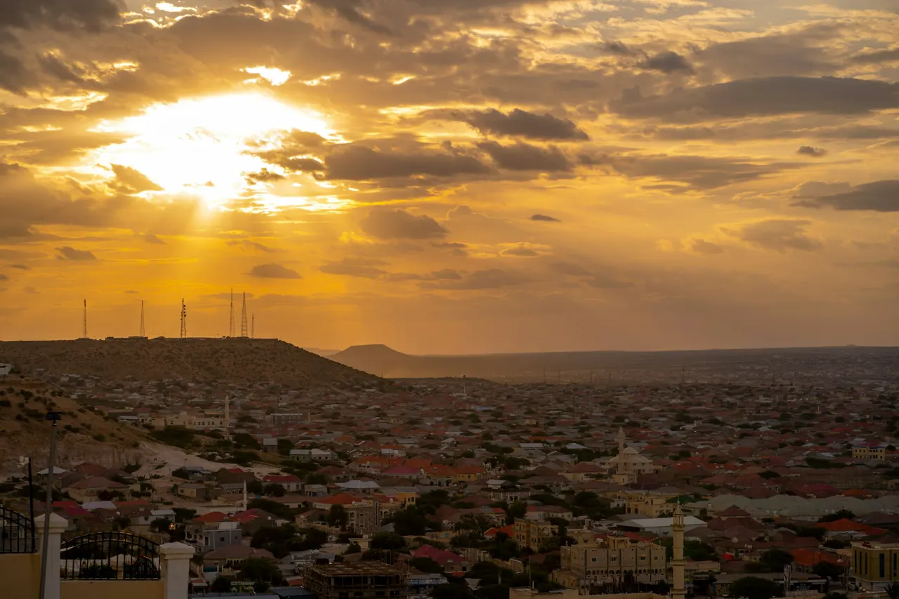 The sun descends, painting the city in warm, golden light