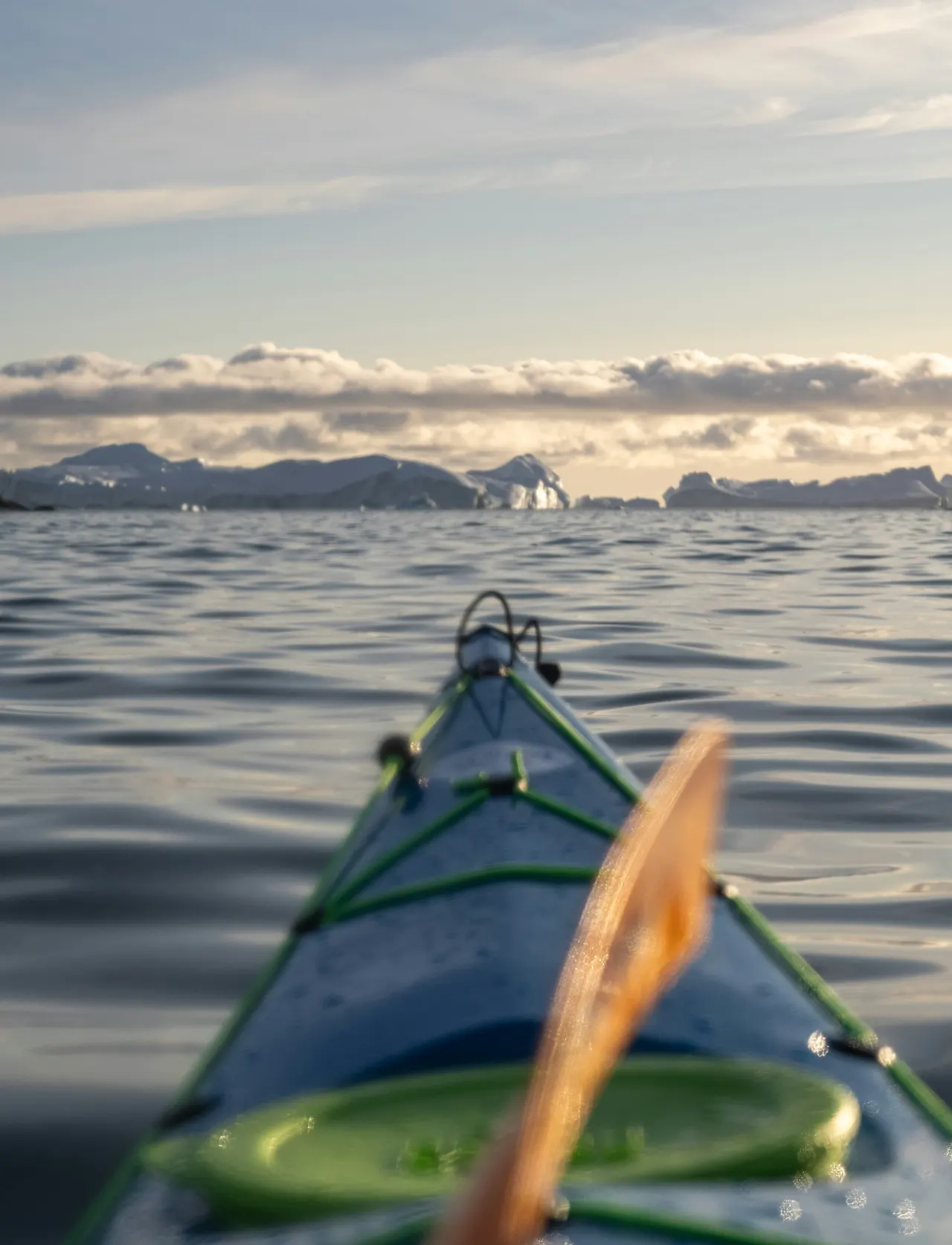 a green and blue kayak in the water