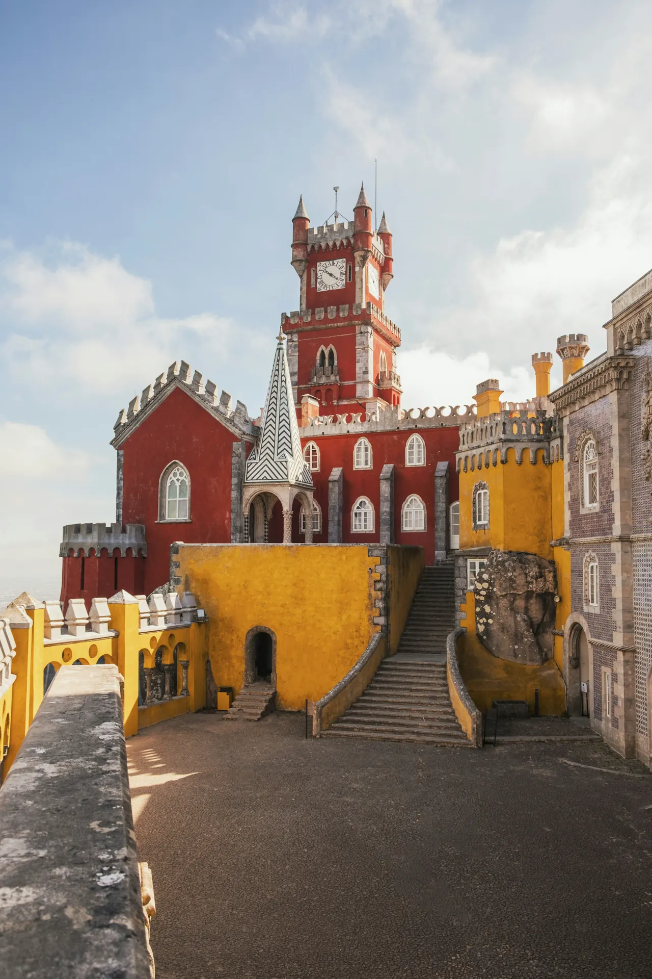 The red and yellow Pena Palace with a clock tower in Sintra, Portugal