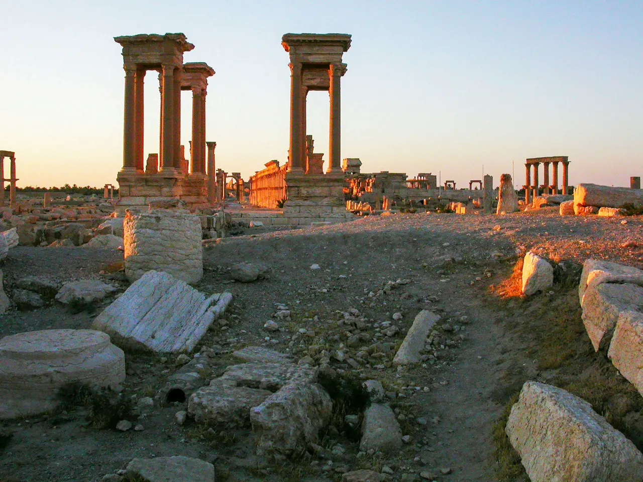 Ancient ruins stand bathed in warm sunlight