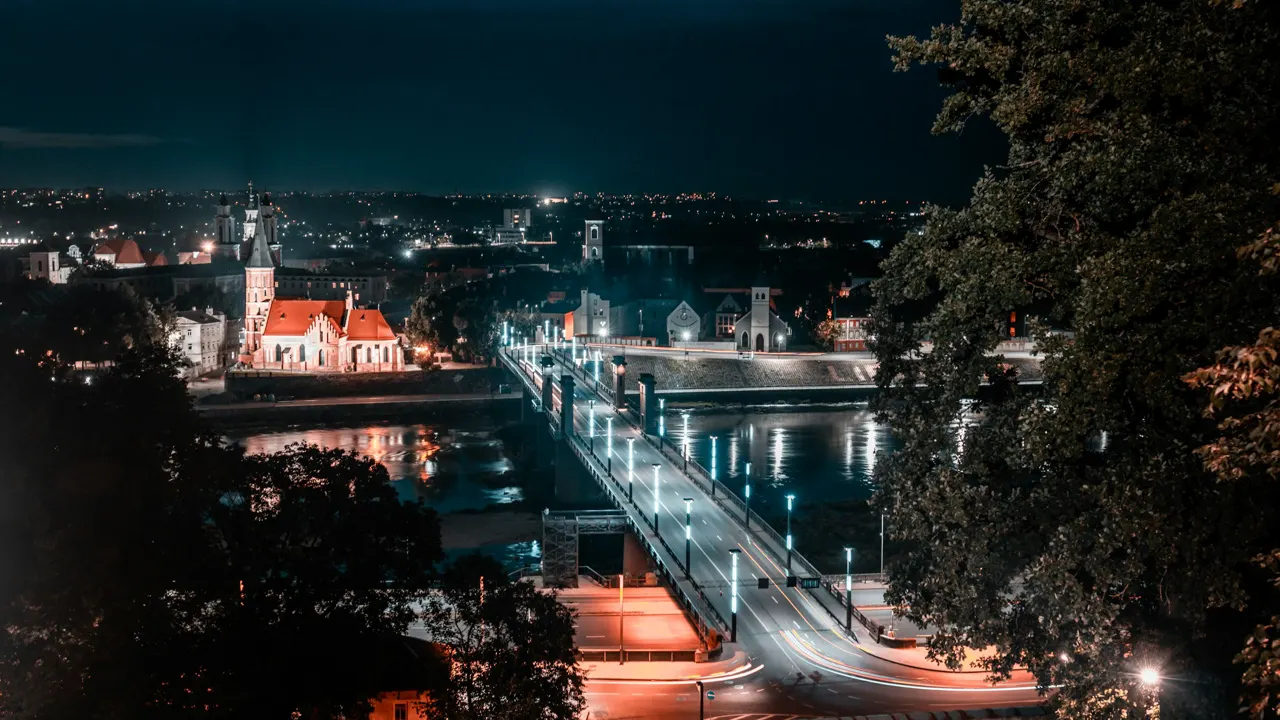 a view of a city at night from a hill