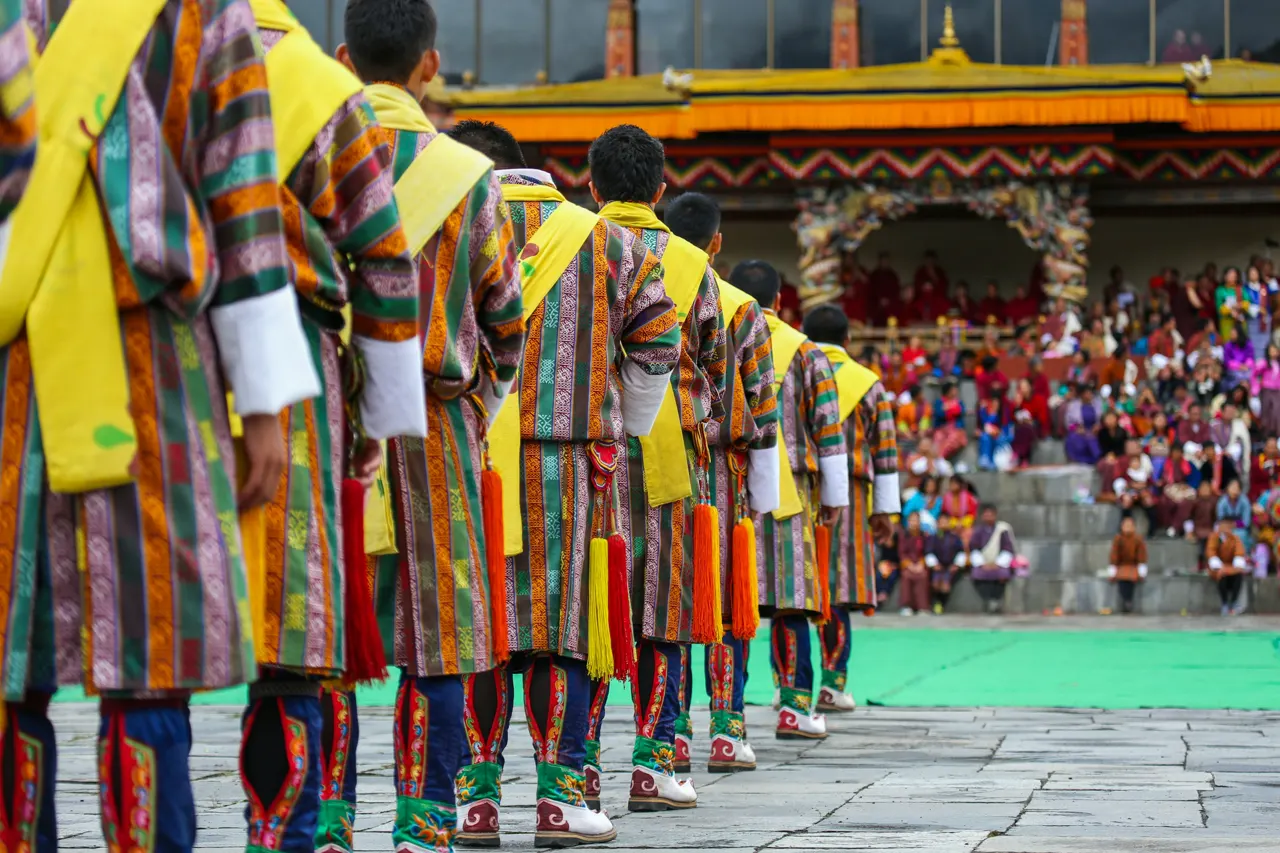 A group of male dancers get ready for a traditional item during Thimphu Tshechu (festival)