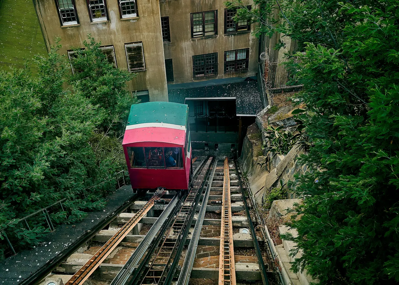 a train traveling through a tunnel next to a tall building
