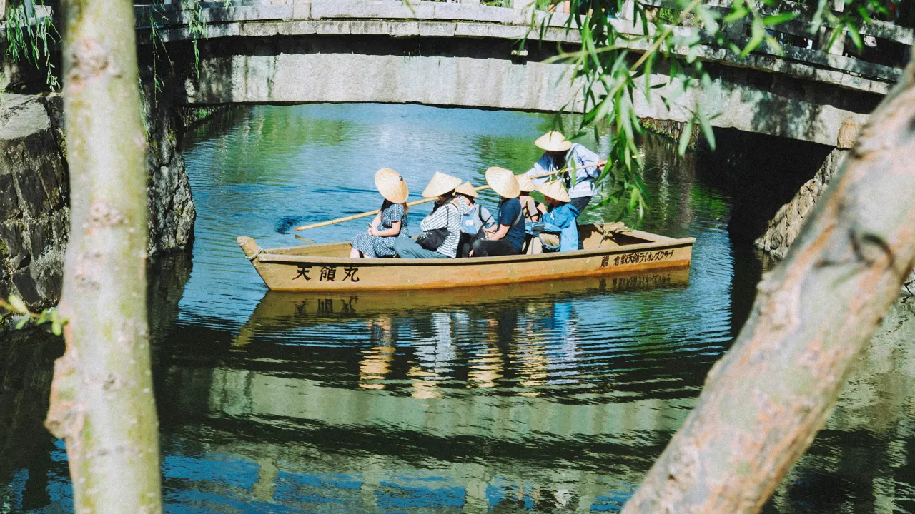 A group of people riding in a boat on a river