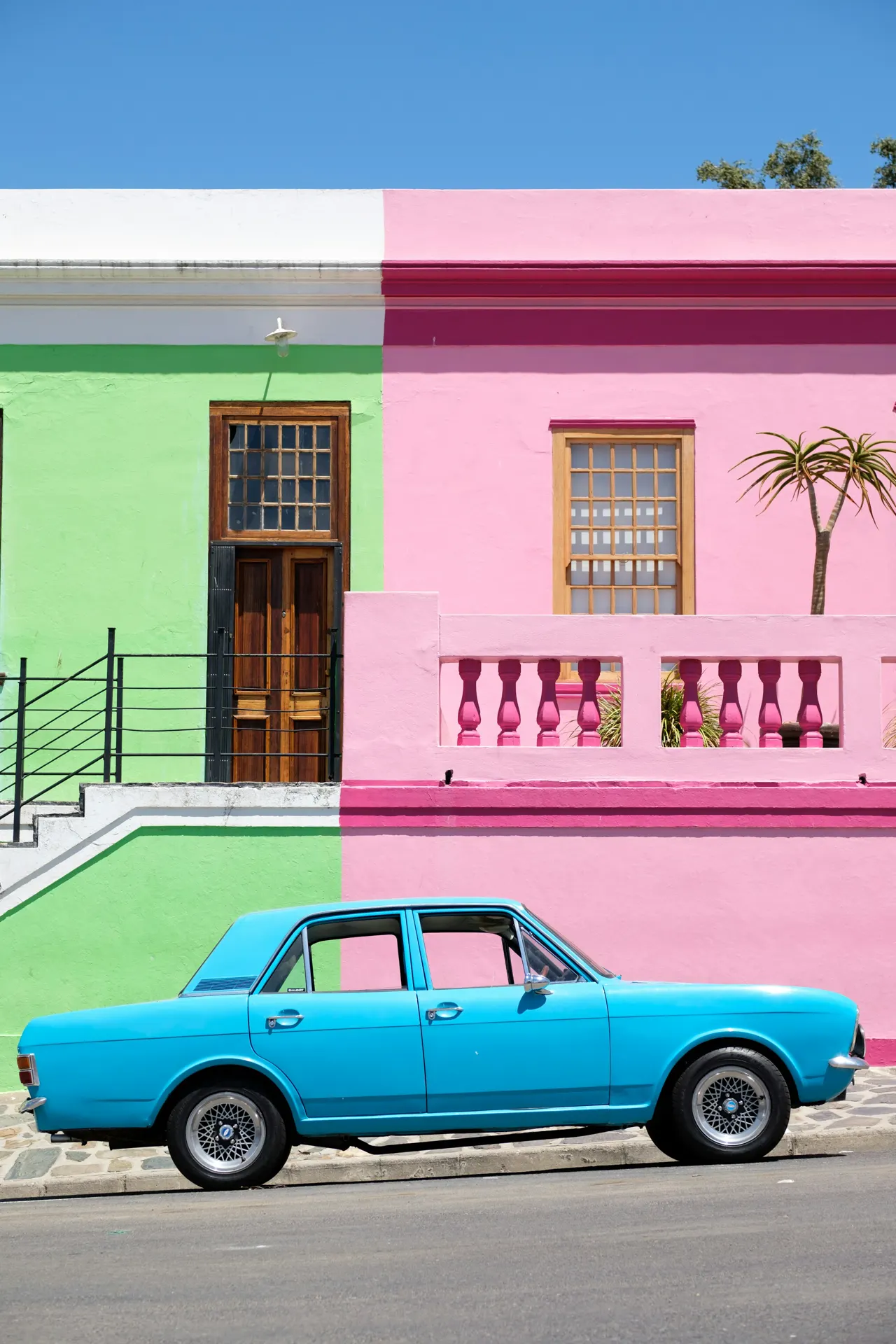 A colorful portait of an old blue sedan vehicle in the Bo-Kaap