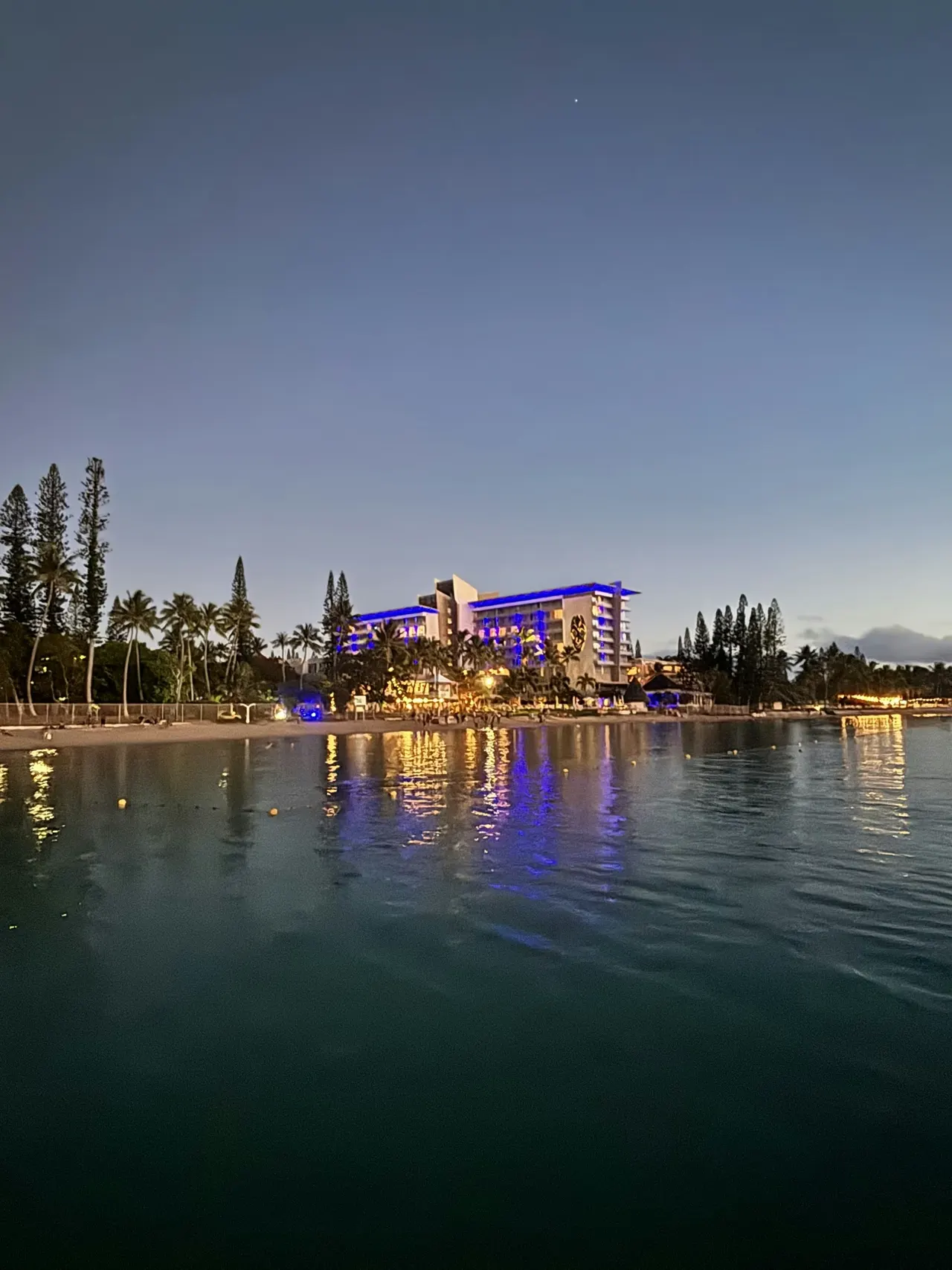 a large body of water with a building in the background