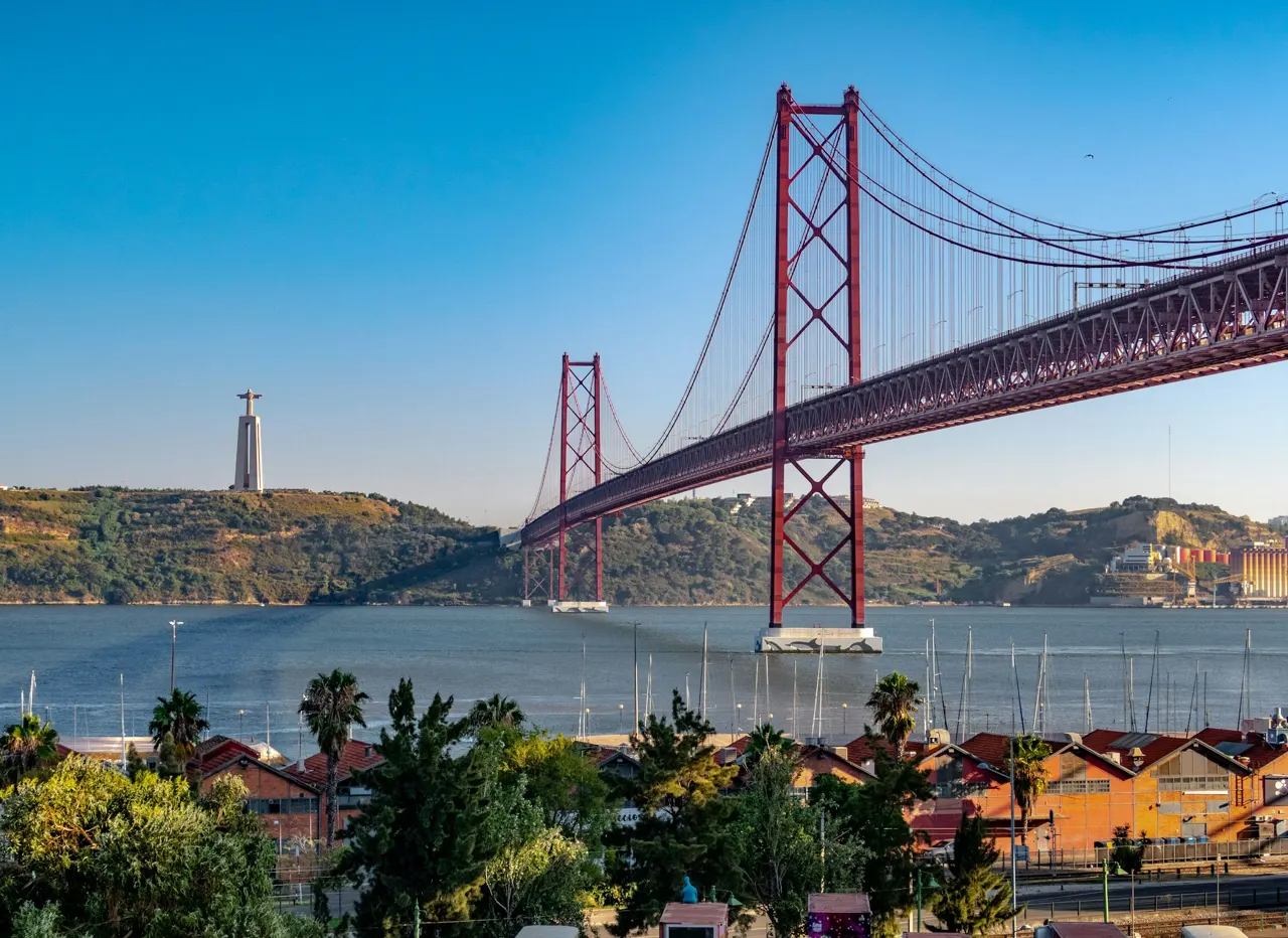 The 25 de Abril Bridge and Christ the King statue in Lisbon, Portugal