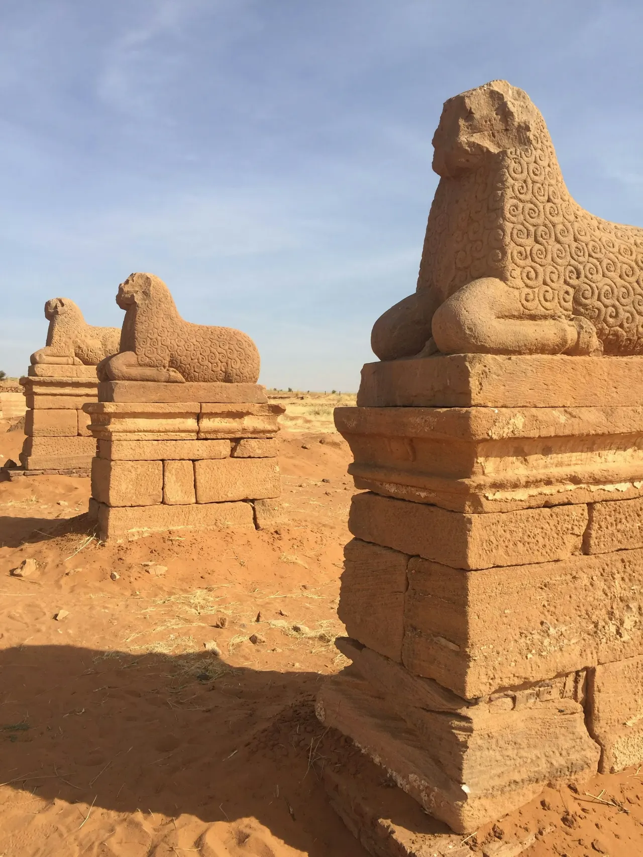 Ancient stone lion statues in a desert landscape