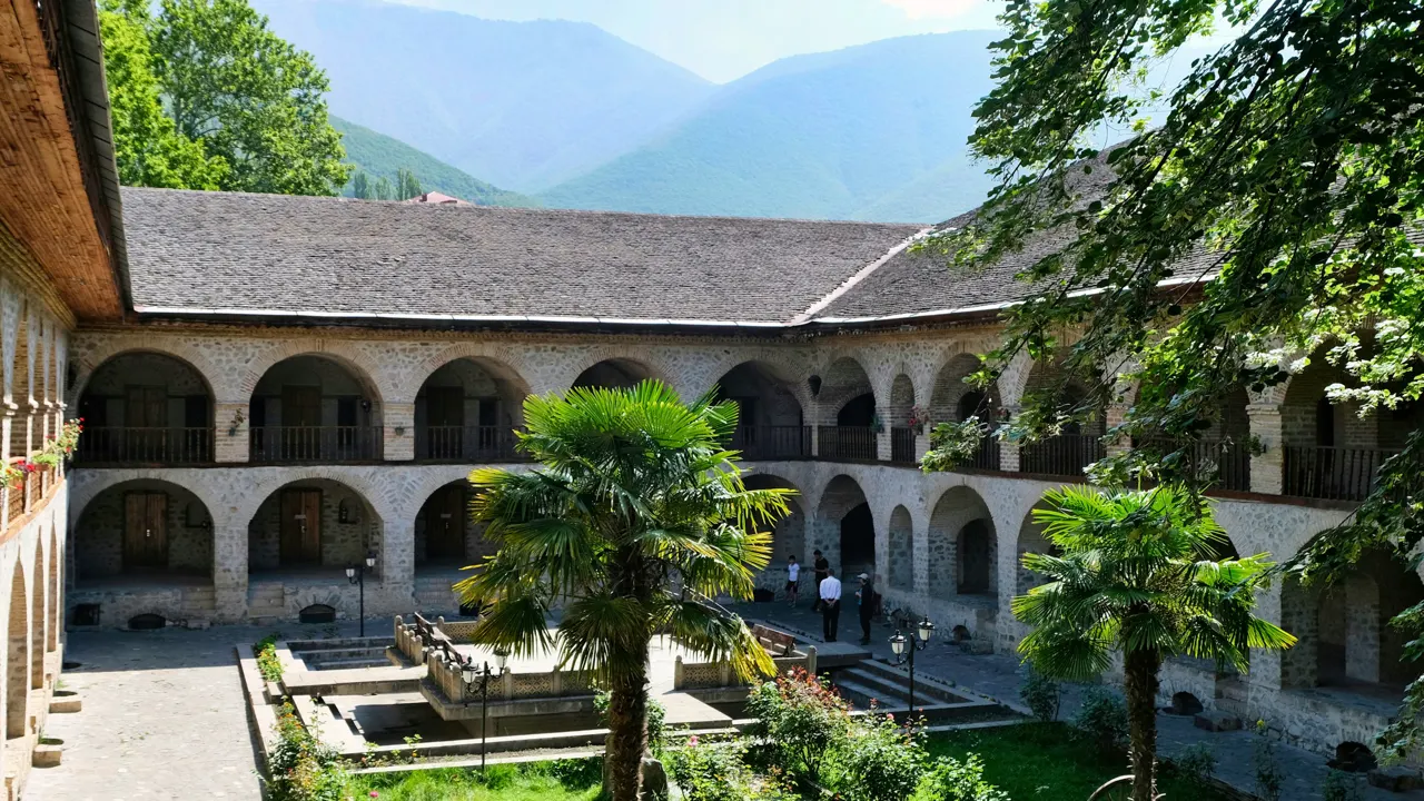 a courtyard of a building with a fountain in the middle