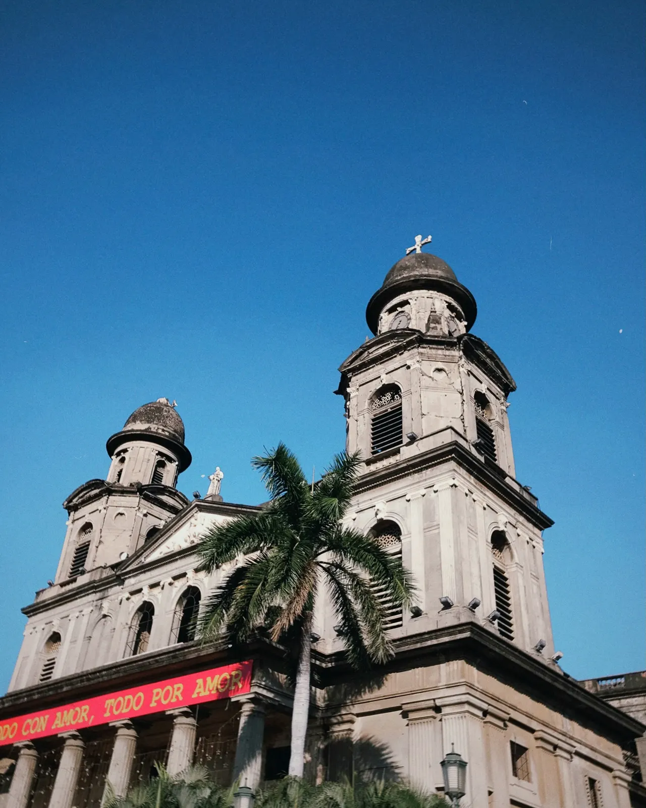 a church with a palm tree in front of it