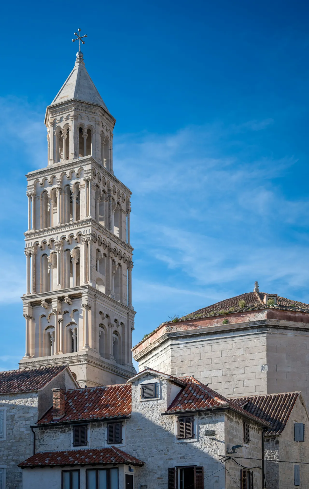 a tall tower with a cross on top of it