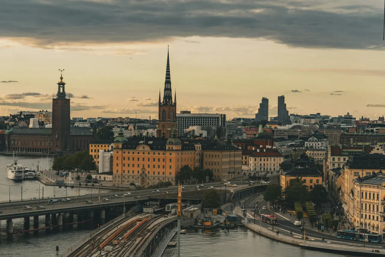A view of a city with a bridge in the foreground