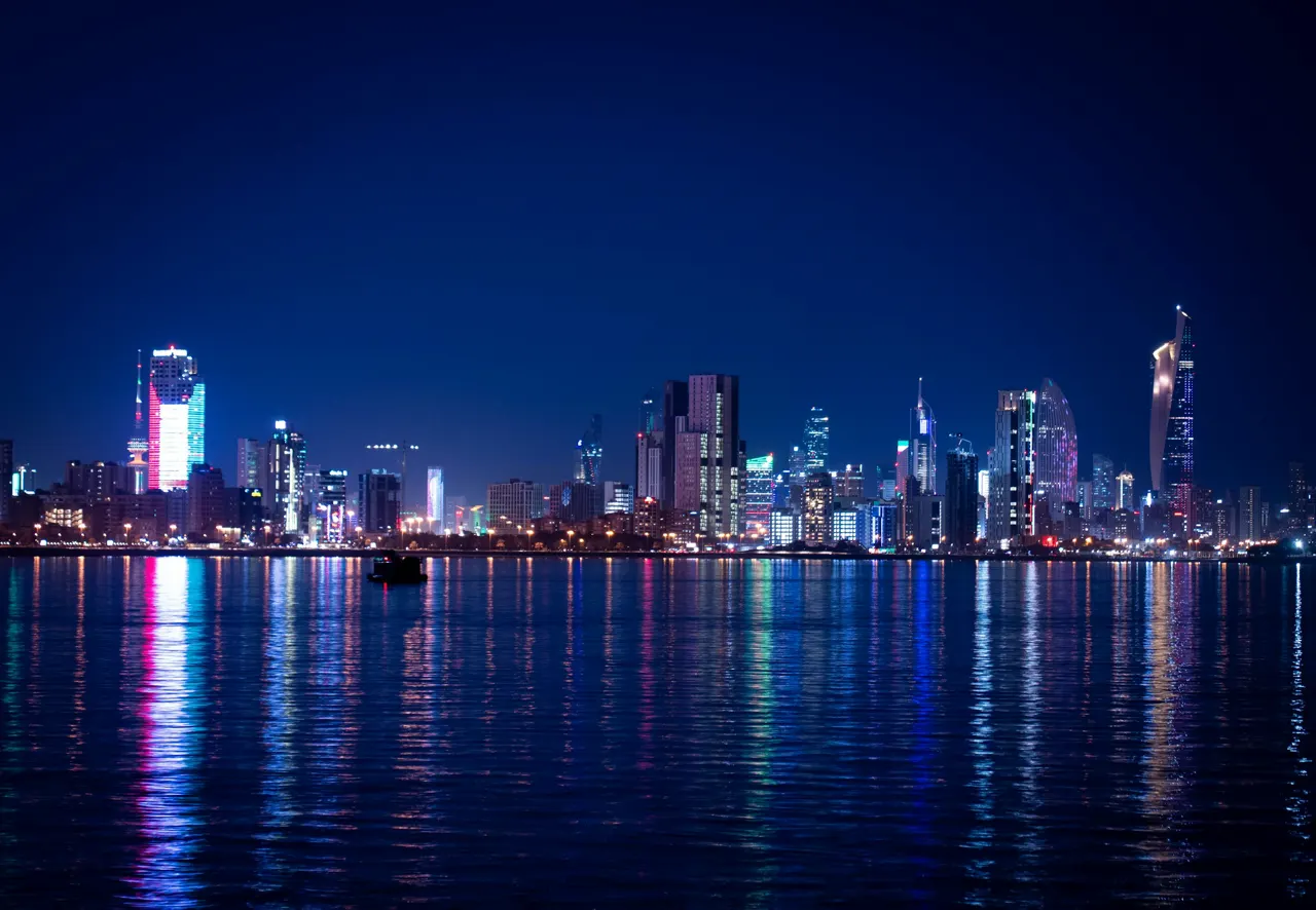 City skyline illuminated at night with water reflections
