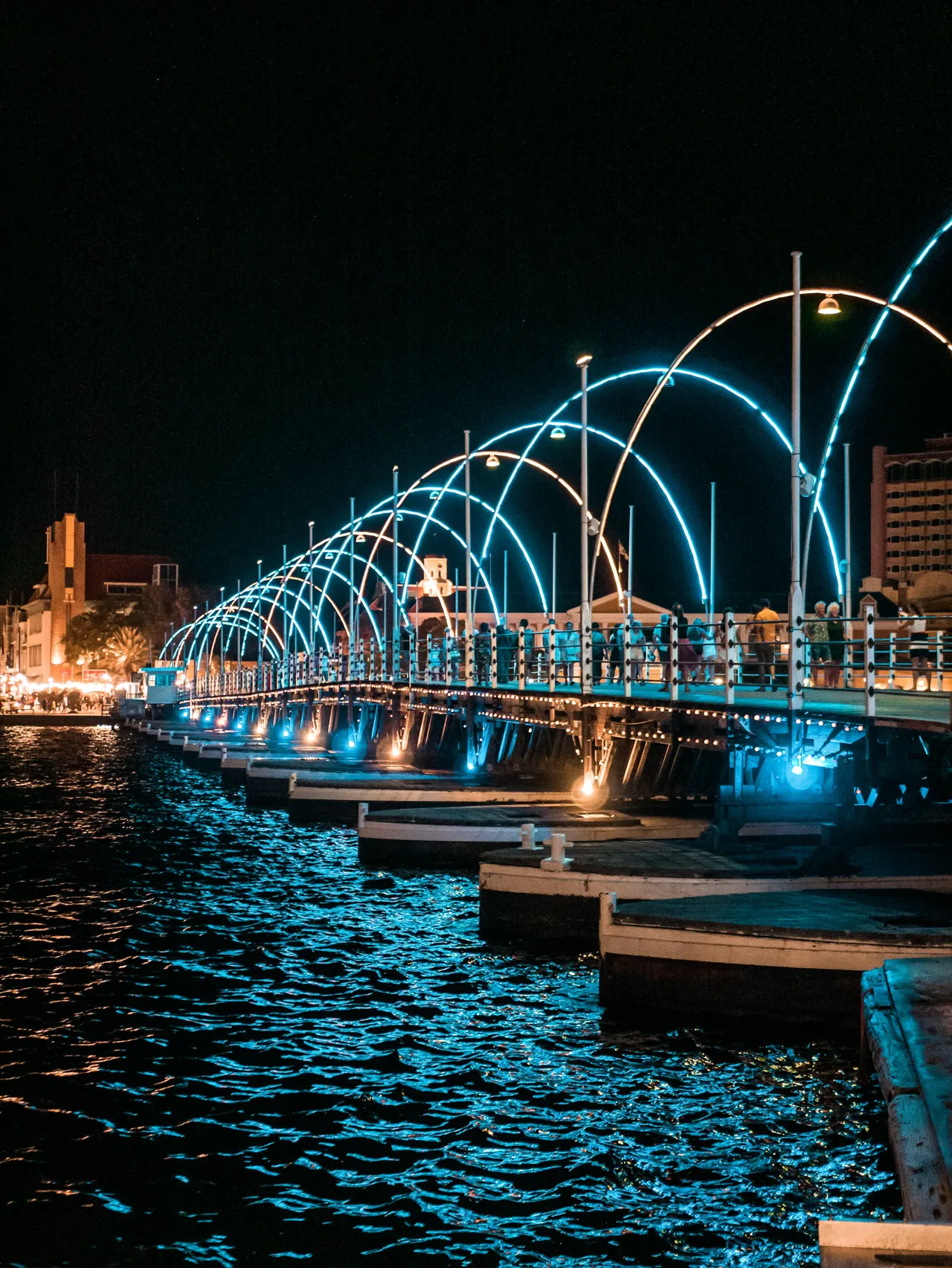 a long bridge over a body of water at night