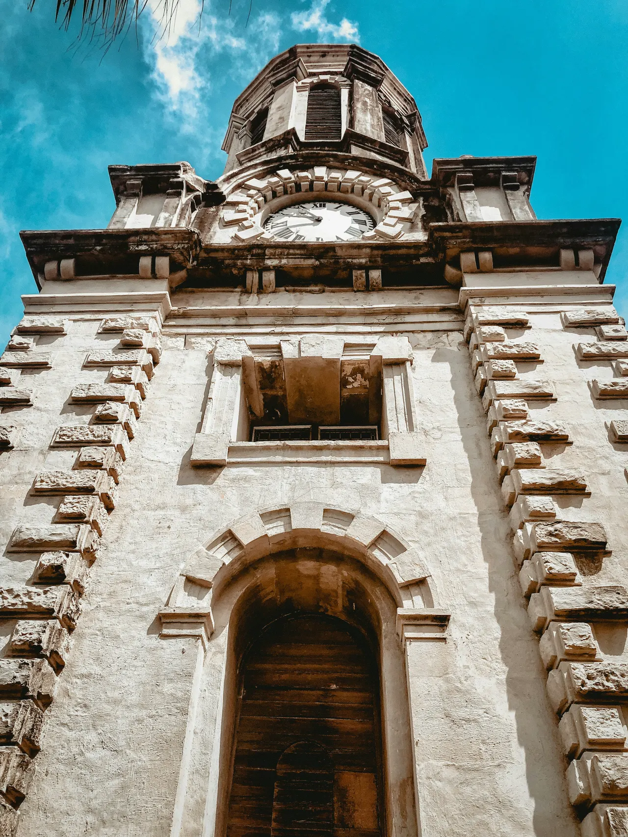 A tall tower with a clock on the top of it
